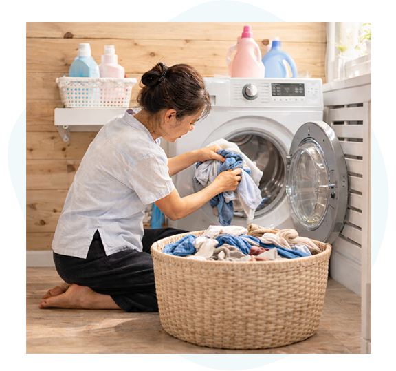 Local staff working at a laundry service in Hoi An, carefully washing travelers' clothes